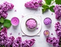 Sea salt spa set with pink lilac flowers. Top view Royalty Free Stock Photo