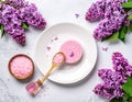 Sea salt spa set with pink lilac flowers. Top view Royalty Free Stock Photo