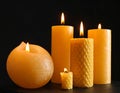 Burning wax candles on black background, closeup Royalty Free Stock Photo