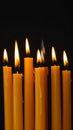 Burning wax candles on black background, closeup Royalty Free Stock Photo