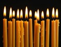 Burning wax candles on black background, closeup Royalty Free Stock Photo