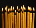 Burning wax candles on black background, closeup Royalty Free Stock Photo