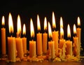 Burning wax candles on black background, closeup Royalty Free Stock Photo