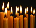 Burning wax candles on black background, closeup Royalty Free Stock Photo