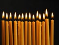 Burning wax candles on black background, closeup Royalty Free Stock Photo