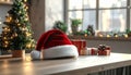 Santa Hat on Wooden Table with Christmas Tree Lights and Festive Decor Indoors Royalty Free Stock Photo