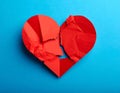 Ragged red heart made from paper on blue background Royalty Free Stock Photo