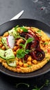 Served over creamy peppery chickpeas with fried octopus, crispy cucumber and radish Royalty Free Stock Photo