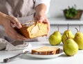 Woman with slice of pear bread at white marble table, closeup. Homemade cake Royalty Free Stock Photo