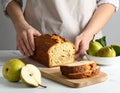 Woman with slice of pear bread at white marble table, closeup. Homemade cake Royalty Free Stock Photo