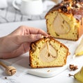 Woman with slice of pear bread at white marble table, closeup. Homemade cake Royalty Free Stock Photo