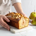 Woman with slice of pear bread at white marble table, closeup. Homemade cake Royalty Free Stock Photo