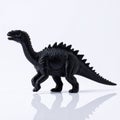 A Toy Dinosaur with a Black Skin Tone and a Spiky Back Royalty Free Stock Photo