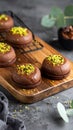 Chocolate pudding cookies with pistachio topping served on a wooden board and decorat Royalty Free Stock Photo