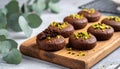 Chocolate pudding cookies with pistachio topping served on a wooden board and decorat Royalty Free Stock Photo