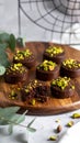 Chocolate pudding cookies with pistachio topping served on a wooden board and decorat Royalty Free Stock Photo