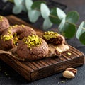 Chocolate pudding cookies with pistachio topping served on a wooden board and decorat Royalty Free Stock Photo