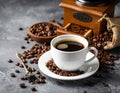 Fresh black coffee in white ceramic cup placed on saucer near coffee grinder and coffee Royalty Free Stock Photo