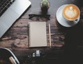 top view minimalist workspace with laptop and latte coffee on wooden desk Royalty Free Stock Photo