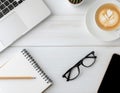 top view minimalist workspace with laptop and latte coffee on wooden desk Royalty Free Stock Photo