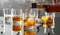 Pouring tasty whiskey from bottle into glass at mirror table, closeup Royalty Free Stock Photo