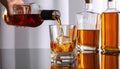 Pouring tasty whiskey from bottle into glass at mirror table, closeup Royalty Free Stock Photo