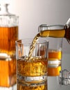 Pouring tasty whiskey from bottle into glass at mirror table, closeup Royalty Free Stock Photo