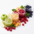 Four jars filled with colorful fruit purees are arranged on a white background. Royalty Free Stock Photo