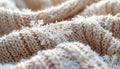 Snowflake on warm beige knitted sweater. Cozy winter background with soft wool texture and Christmas holiday concept. Royalty Free Stock Photo