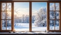 Winter window view of a snowy sunrise landscape with frost patterns. Cozy home scene with falling snow and a warm candle Royalty Free Stock Photo