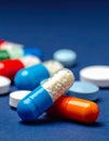 Colorful pills closeup on dark blue background Royalty Free Stock Photo