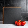 Mock-up for food bars cafes restaurant pizzerias with slate and tomato Royalty Free Stock Photo