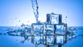 Ice cubes and splashing water on blue gradient background Royalty Free Stock Photo