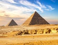 Two large pyramids dominate a desert landscape in Giza, Egypt Royalty Free Stock Photo