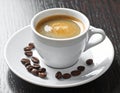 A white ceramic espresso cup sits on a matching saucer, filled with fresh espresso Royalty Free Stock Photo