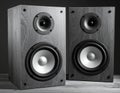 Two wooden speakers with a natural grain finish stand side by side Royalty Free Stock Photo