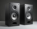 Two black, rectangular bookshelf speakers with a wood grain finish are shown Royalty Free Stock Photo