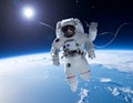 Astronaut in a white space suit floats above Earth, with the planet\'s blue and white surface visible below Royalty Free Stock Photo