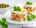 A neatly plated Russian salad on a white plate, garnished with fresh parsley Royalty Free Stock Photo