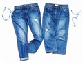 Two pairs of blue denim jeans with a distressed design are placed side by side Royalty Free Stock Photo