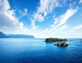 Clear blue ocean with two small, lush green islands Royalty Free Stock Photo