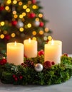 Christmas advent wreath with burning candles. Lights on x-mas tree in background Royalty Free Stock Photo