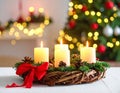 Christmas advent wreath with burning candles. Lights on x-mas tree in background Royalty Free Stock Photo