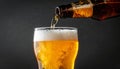 Closeup pour light ale beer in pint glass over black background Royalty Free Stock Photo