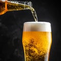 Closeup pour light ale beer in pint glass over black background Royalty Free Stock Photo