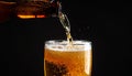 Closeup pour light ale beer in pint glass over black background Royalty Free Stock Photo