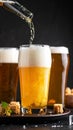 Closeup pour light ale beer in pint glass over black background Royalty Free Stock Photo
