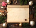 Frame with vintage paper and Christmas decorations on wooden background Royalty Free Stock Photo