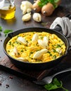 Frying pan with scrambled eggs stuffed with edible yucca flowers.Diet omelet Royalty Free Stock Photo