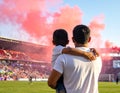 A man and a child, both wearing white shirts, are standing in a stadium filled with people Royalty Free Stock Photo